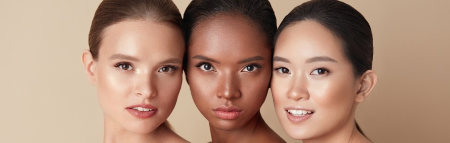 Three models with different skin tones posed cheek to cheek