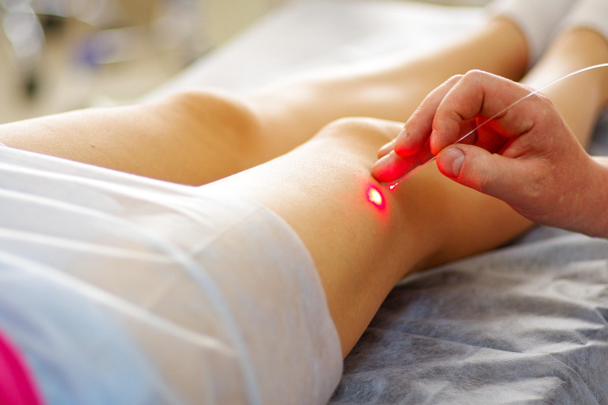 Laser treatment on a patient's leg in a clinic