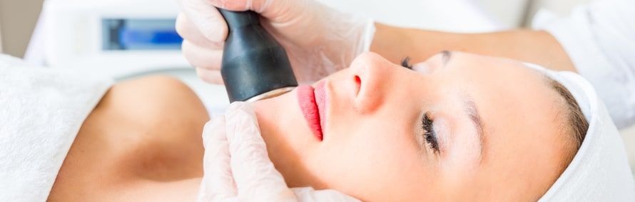 Model lying back during a laser facial treatment