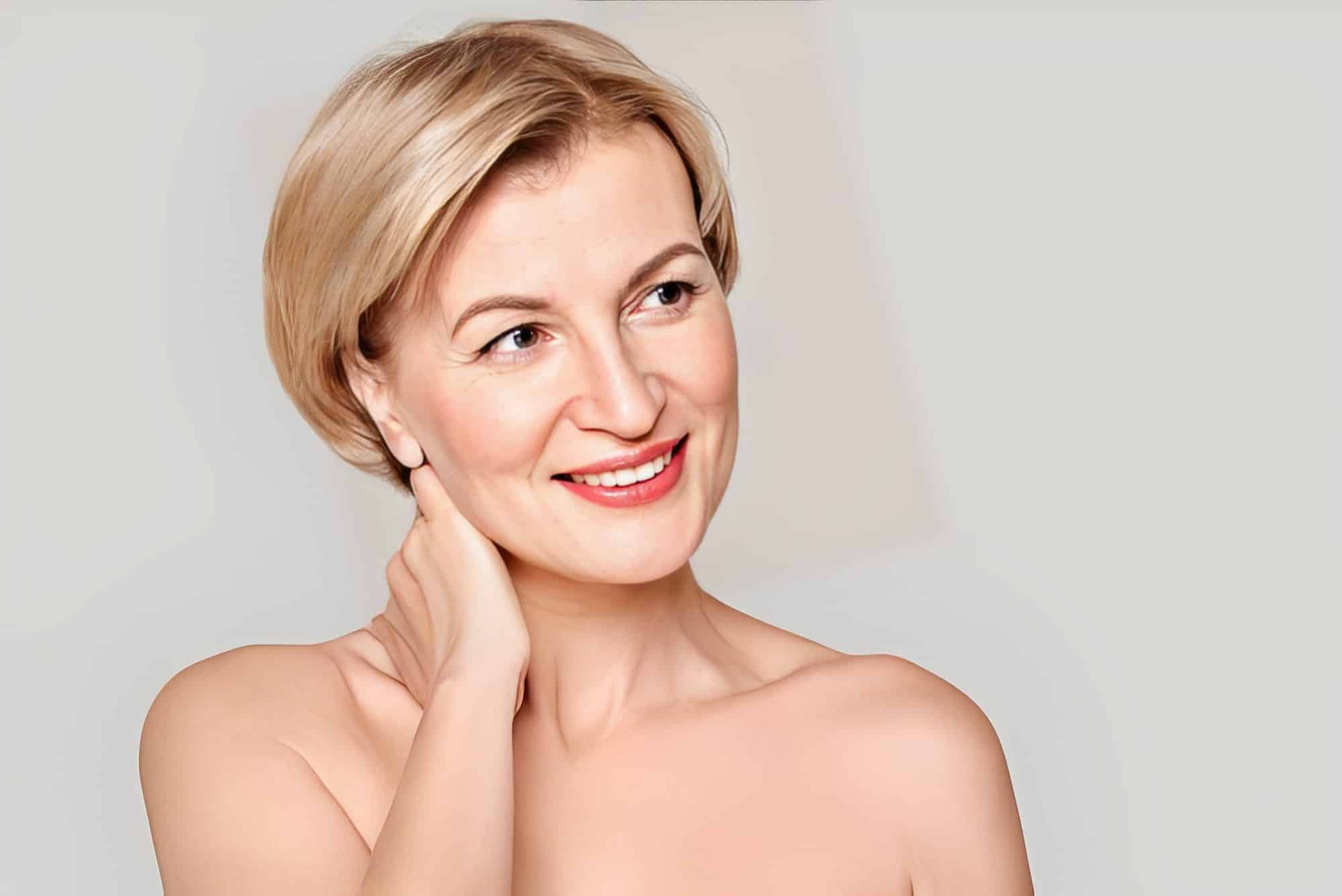 Portrait of middle aged model smiling wide and looking aside