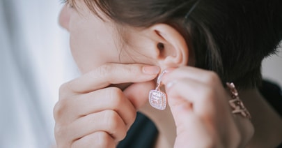 Model with an earring, a hand at her earlobe