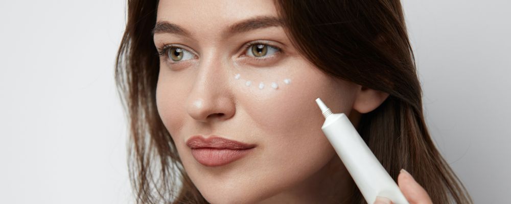 Beautiful Woman Applying Eye Cream On Skin Under Eyes